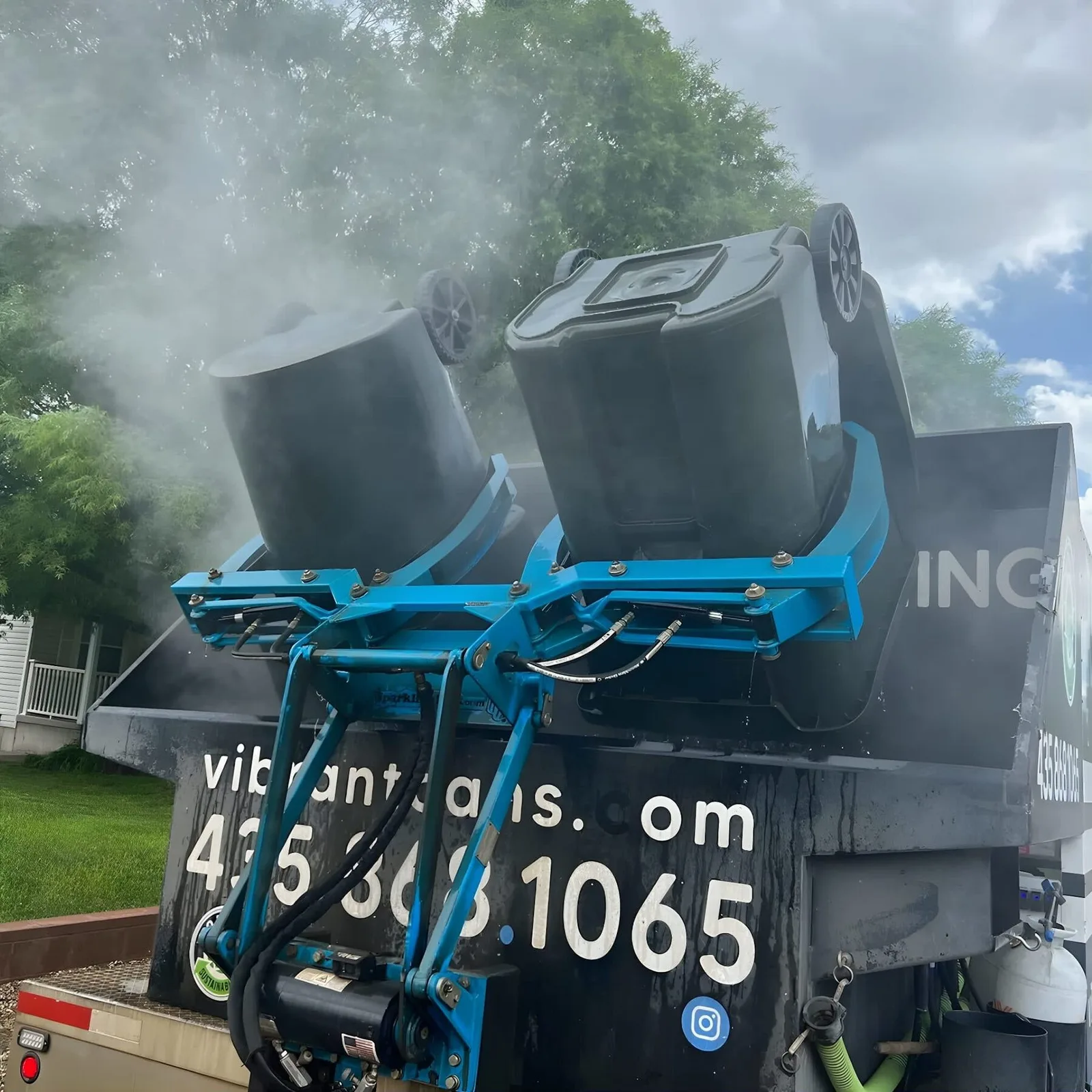 Vibrant Cans truck cleaning a residential trash can